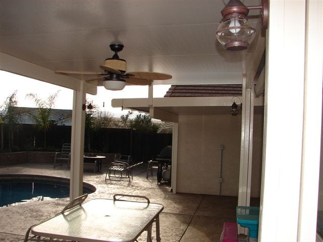 A covered patio with a ceiling fan