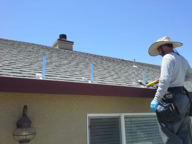 A person checking a roof